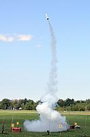 Daniel pulls a rocket out of a big puff of smoke